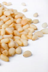 Fresh peeled cedar nuts isolated on white background, closeup