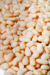 Fresh peeled cedar nuts isolated on white background, closeup