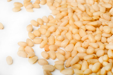 Fresh peeled cedar nuts isolated on white background, closeup