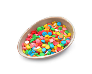 Sweet chocolate egg with sprinkles on white background