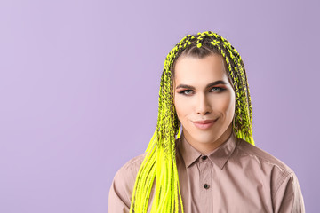 Portrait of young transgender woman on color background