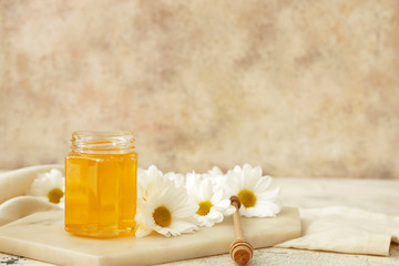 Jar of sweet honey on table