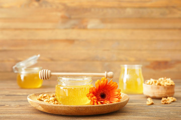 Jar of sweet honey on table