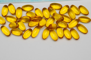 Close up of food supplement oil filled capsules suitable for: omega 3, omega 6, vitamin A, vitamin D, vitamin E