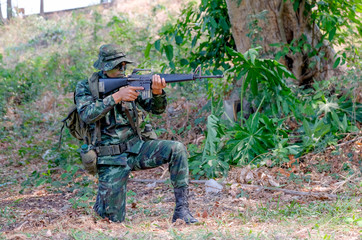 Soldier man with backpack point the gun to front direction and prepare for fight the enemy.