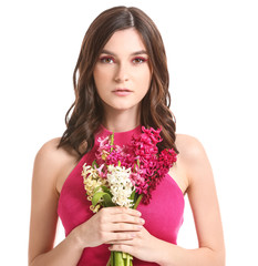 Beautiful young woman with hyacinth flowers on white background