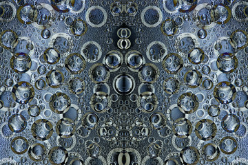 Pattern of randomly interwoven rings of different diameters and white, silver and copper colors symmetrically located on a blue background. Abstract fantasy. 