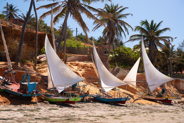 Rafts with open sails on a sunny afternoon at Vila Nova beach, Icapui, Ceara, Brazil on September...