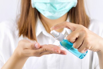 The girl's hand is cleaning her hands with Spay Alcohol. To get rid of various germs and viruses.