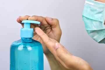 Health concept, young woman's hand is cleaning hands with alcohol gel To get rid of various germs and viruses.