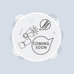 Male hand holding megaphone with coming soon speech bubble. Loudspeaker