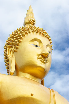 The biggest sitting Buddha image in Thailand at Wat Muang Temple. The image, made of cement and painted in gold color.