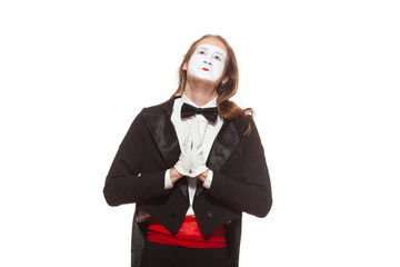 Portrait of male mime artist performing, isolated on white background. Man folded his hands in...