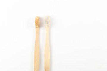 Close-up of toothbrushes made from eco materials, natural wood. On white background