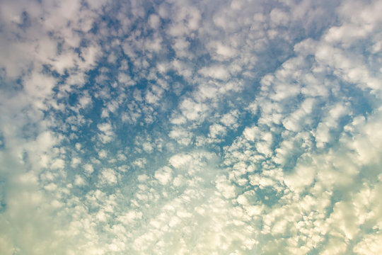 Fluffy white clouds flying on blue sky background - Color filter style pictures