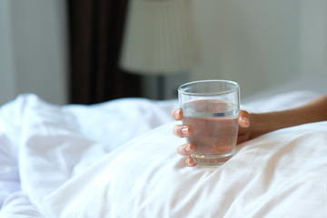 man drinking a glass of water