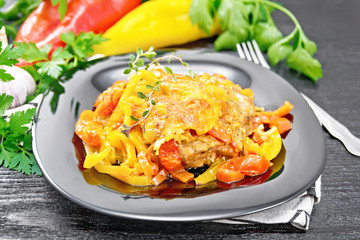 Chicken with pepper in plate on black board