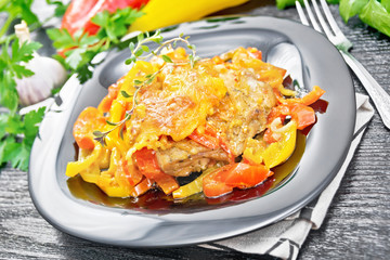Chicken with pepper in plate on board