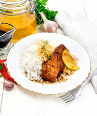 Salmon with sauce in plate on light board