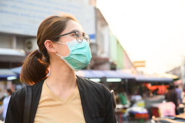 Woman wearing surgical mask for protect bad air pollution or virus in pandemic situations....