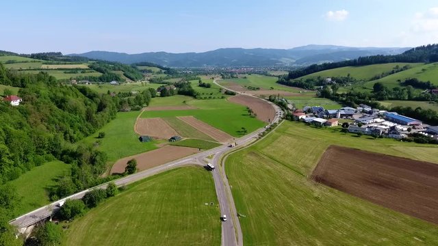 drone flight over a crossroads near a small village in a valley of the black forrest