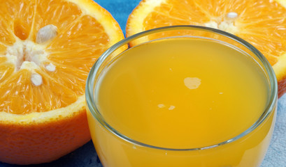 Fototapeta na wymiar freshly squeezed orange juice and half an orange close-up
