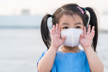 A little girl wearing mask for prevent the spread of the Covid-19, Covic 19 virus protection...