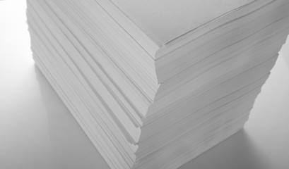 Stack of white office paper on light background, top view, place for text.