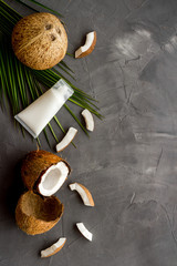 Fototapeta na wymiar Skin care cream with coconut oil on grey background top-down frame copy space