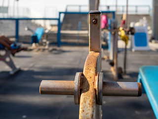 Close up of rusted weight rack in outdoor gym