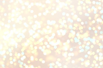 Shiny bokeh champagne color abstract texture. Holiday pastel beige background. Golden lights pattern.
