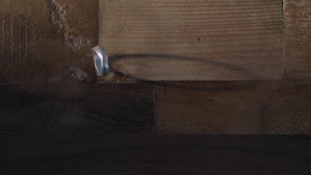 Reflection Of The Silver Ring Spinning On The Wooden Floor. -wide shot