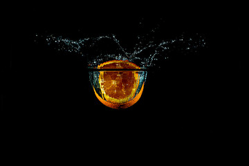 splash orange slice underwater with black background