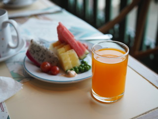 orange juice in clear glass and many fruit on the table