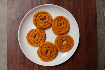 Indian Traditional Snack Chakali, a spiral shaped crisp deep fried snack, It is known as Chakali, Murukku, Muruku, Murkoo, Chakri in Gujarat, Chakli in Maharashtra, Indian festival or Diwali Snacks 