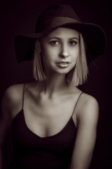 Black and white portrait blondes on black background in a hat and Tank Top With Thin Straps