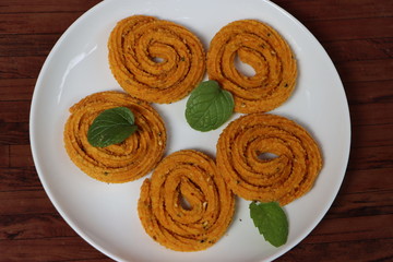 Indian Traditional Snack Chakali, a spiral shaped crisp deep fried snack, It is known as Chakali, Murukku, Muruku, Murkoo, Chakri in Gujarat, Chakli in Maharashtra, Indian festival or Diwali Snacks 