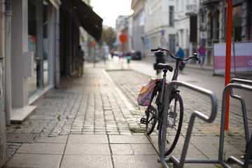 Bicycle parked on the sidewalk somewhere in Europe with blurred street background