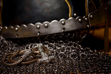 Thor's silver Hammer pendant on the chain, steel chain mail and Viking helmet. Handmade. Mjolnir. Viking's symbol.