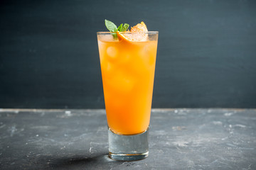 Fresh cocktail with vodka and orange juice on the rustic background. Selective focus. Shallow depth of field.