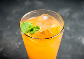 Fresh cocktail with vodka and orange juice on the rustic background. Selective focus. Shallow depth of field.