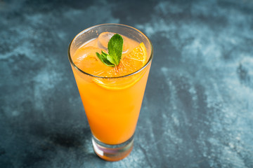 Fresh cocktail with vodka and orange juice on the rustic background. Selective focus. Shallow depth of field.