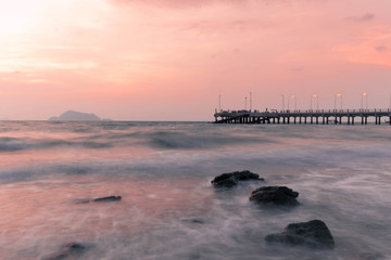 View of the long exposure waves and the sea at dusk from the Loh Jak bridge, KohYao Yai, Phang Nga, Thailand © phungatanee