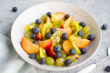 Fresh natural fruit salad bowl with Chia seeds, selective focus