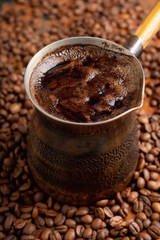 Freshly making coffee in vintage cezve. Selective focus. Shallow depth of field.