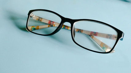 eyeglasses with black frames on a blue background