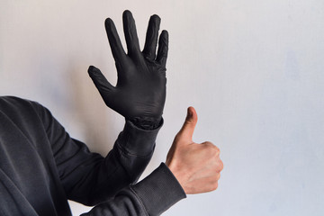 Man hands in black medical gloves closeup. Protecting the body from viruses and bacteria. Hand hygiene, sterile uniform. The fight against epidemic. Safety for your life. Prevention and control