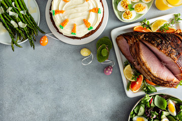 Big traditional Easter brunch with ham, quiche lorraine and carrot cake and copy space for text