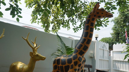 Statue of deer and giraffes in the park.