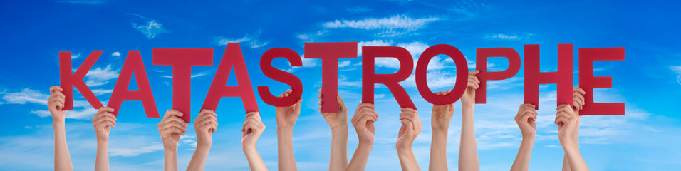 People Hands Holding Colorful German Word Katastrophe Means Catastrophe. Blue Sky As Background